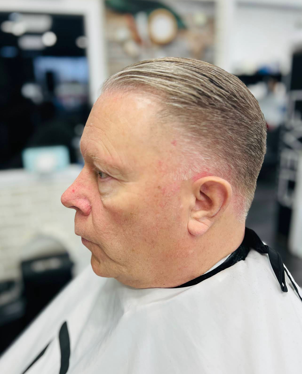 Classic slick-back with skin fade — client side profile